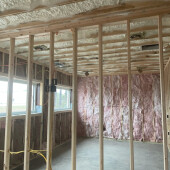 Open cell spray foam insulation with fiberglass interior walls