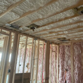 Open cell spray foam insulation with fiberglass interior walls