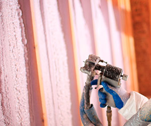 Closeup of spray foam equipment in use.